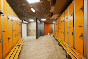 Orange lockers and bench in gym room