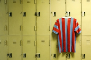 Image shows football locker room iwth tshirt hanging